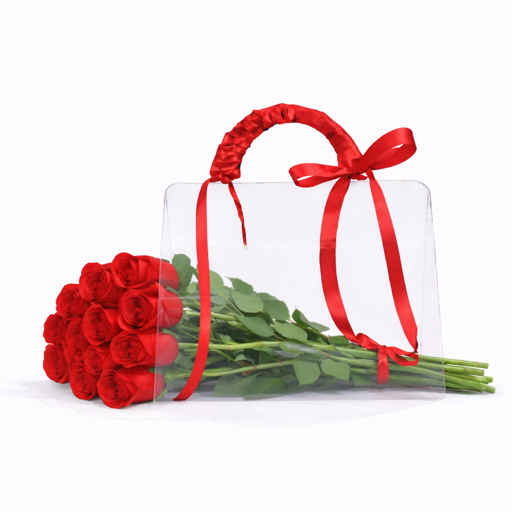 Bouquet of red roses with a clear bag and red ribbon on a white background