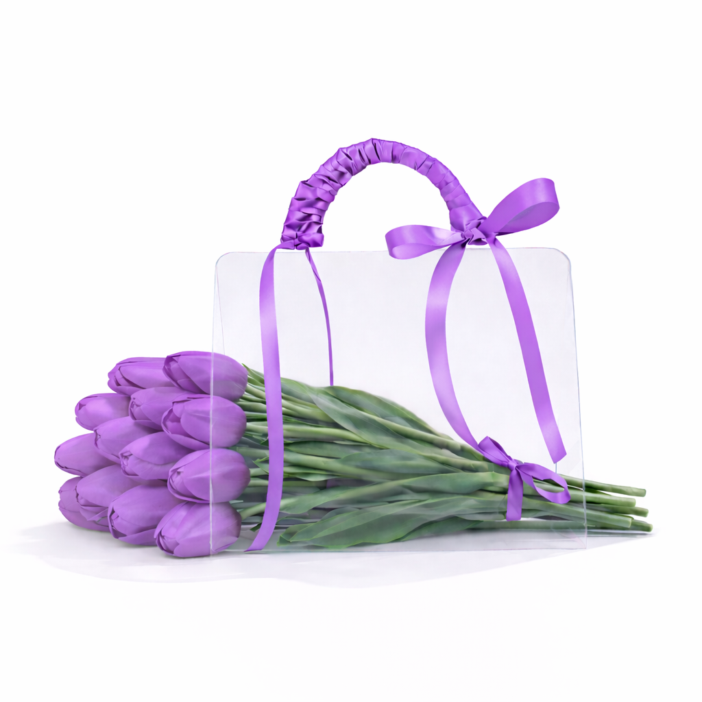 Bouquet of purple tulips with a clear gift bag tied with a purple ribbon on a white background