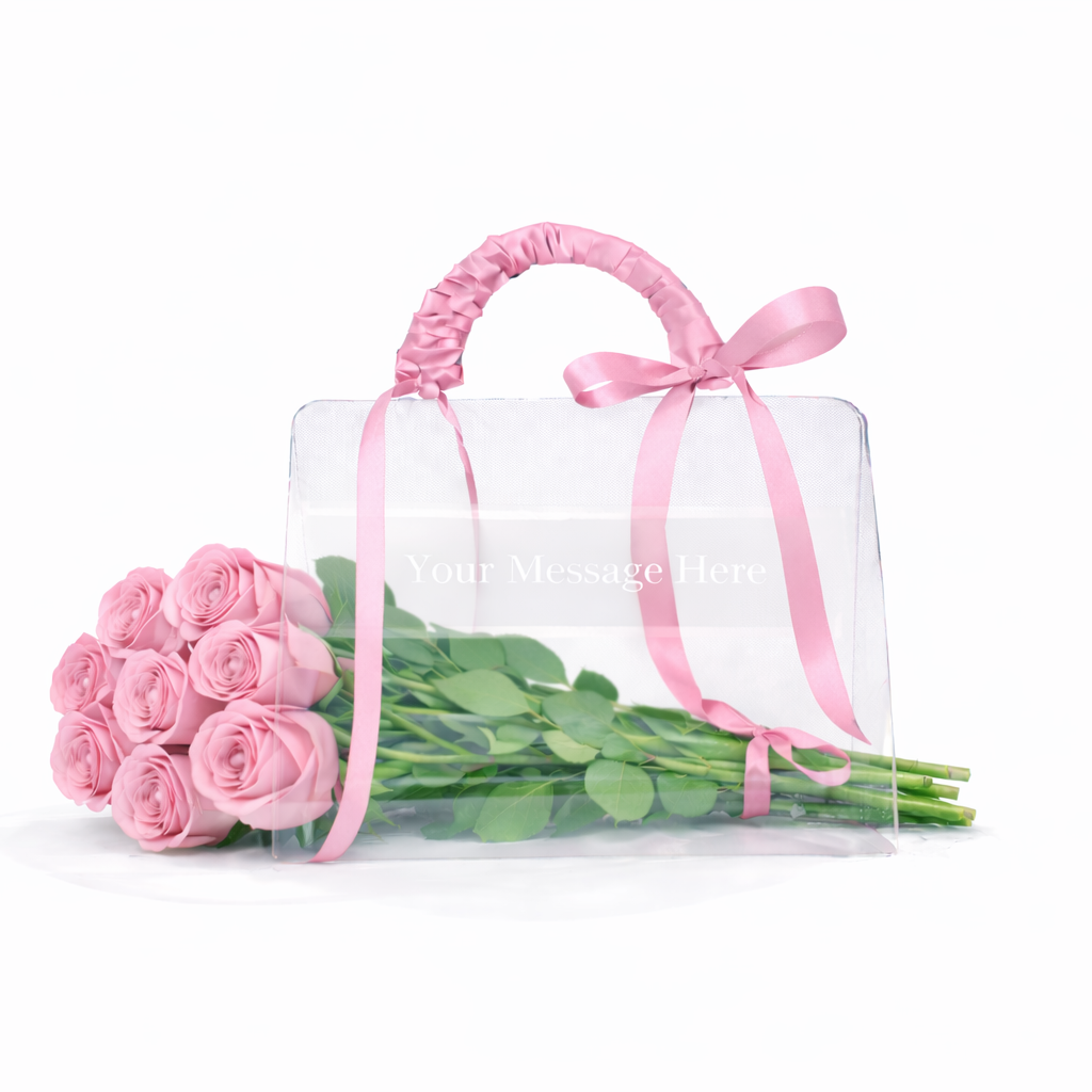 Clear handbag with pink roses and a pink ribbon on a white background