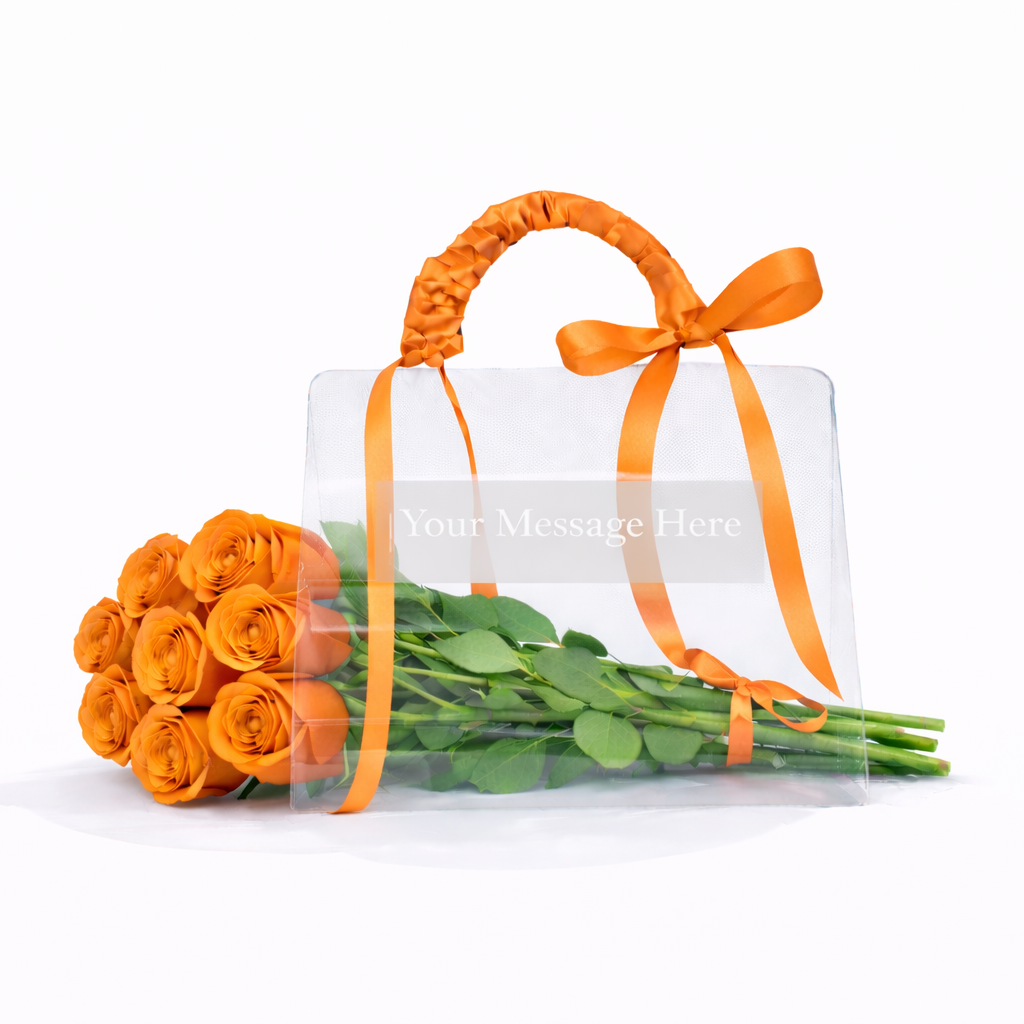 Bouquet of orange roses with a clear gift bag tied with an orange ribbon on a white background.