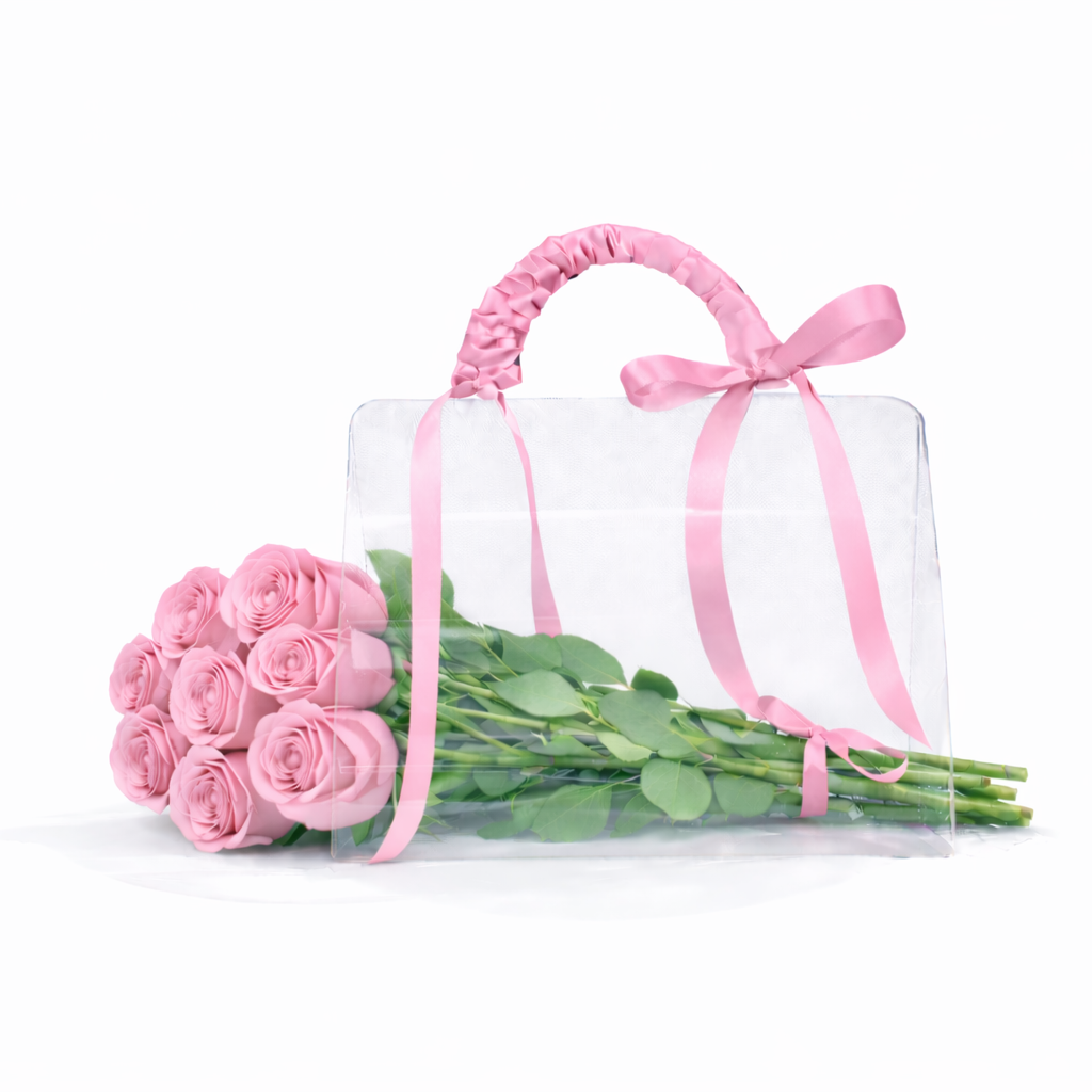 Bouquet of pink roses with a clear glass vase and pink ribbon on a white background