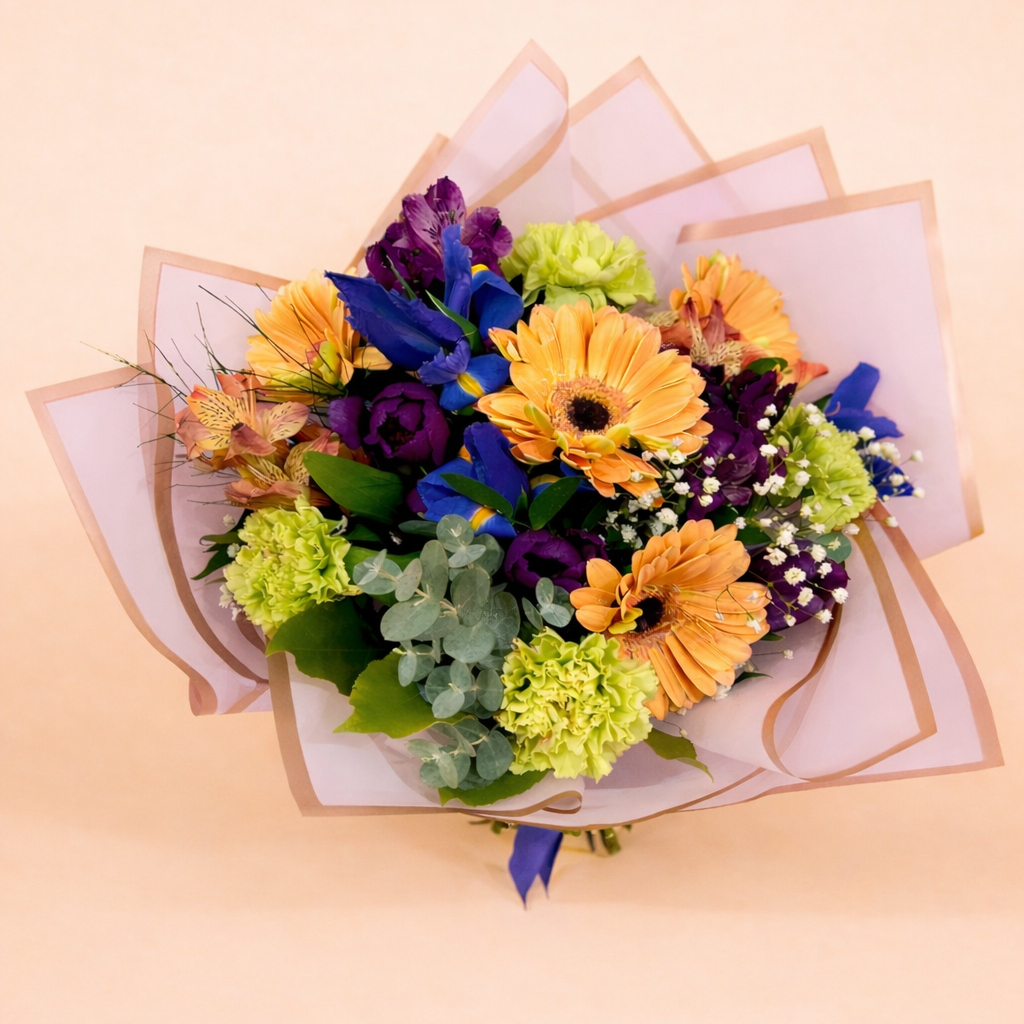 Colorful bouquet of flowers with a light pink background