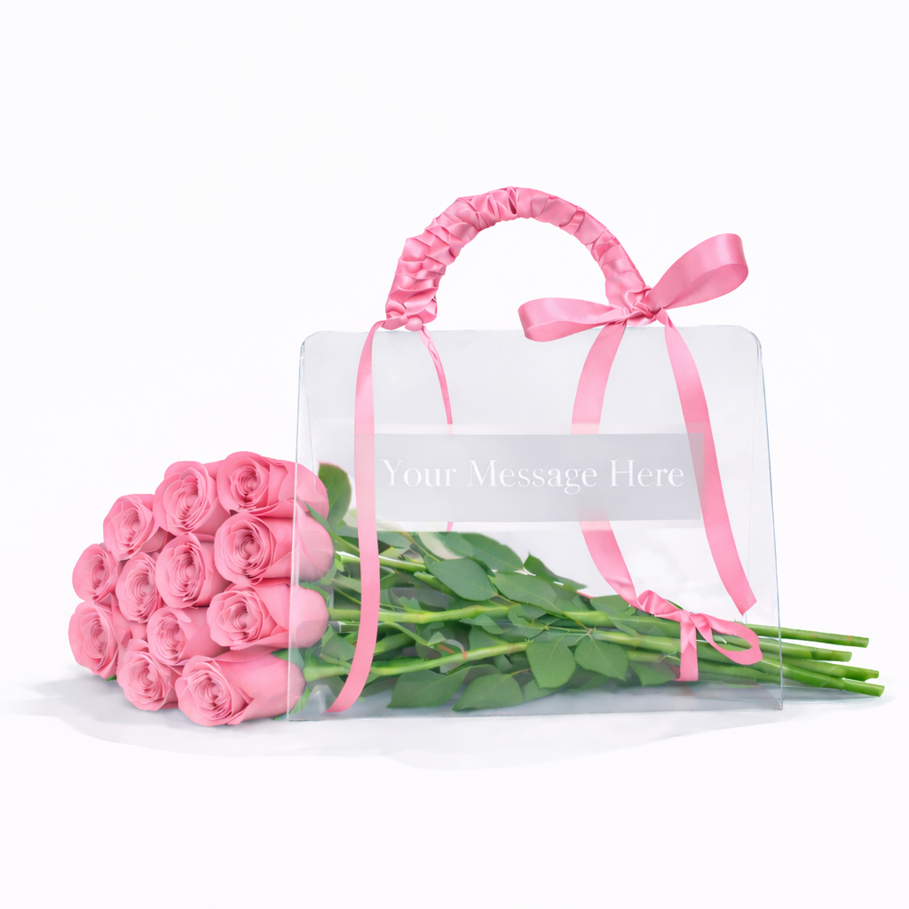 Bouquet of pink roses in a clear bag with a pink ribbon on a white background