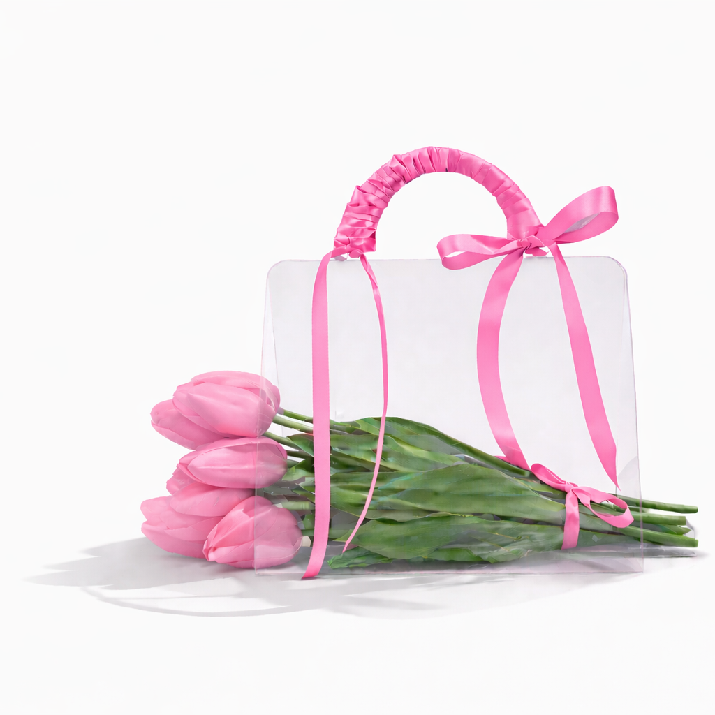 Gift box with pink ribbon and pink tulips on a white background